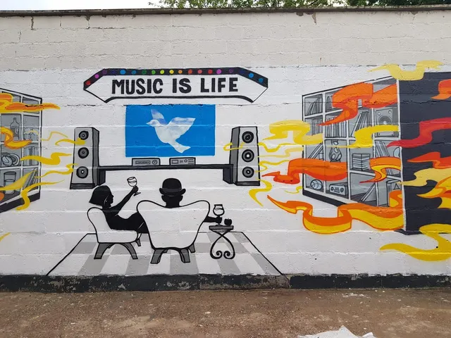 Mural of a silhouetted couple facing speakers beneath the text MUSIC IS LIFE, surrounded by colorful stylized soundwaves