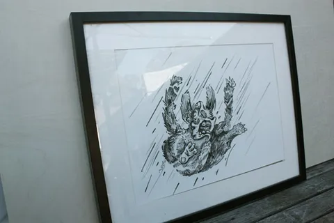 Framed ink drawing of a grotesque creature flailing as it falls rapidly through motion lines