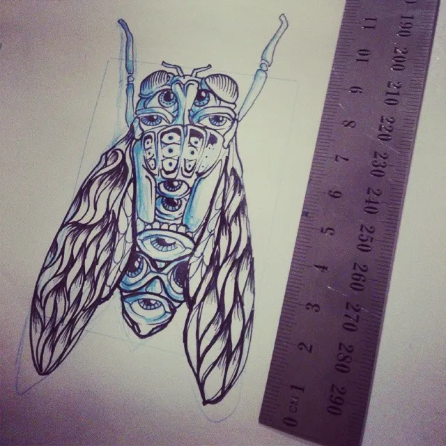 Ink drawing of a stylized cicada with multiple eyes and symmetrical patterns, shown next to a metal ruler