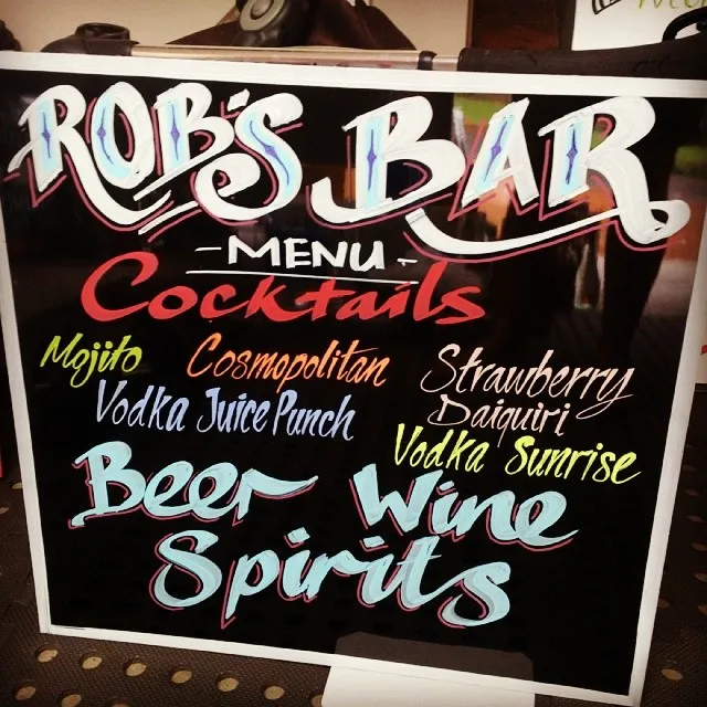Hand-painted black menu board for Rob's Bar with colorful custom lettering for cocktails, beer, wine and spirits