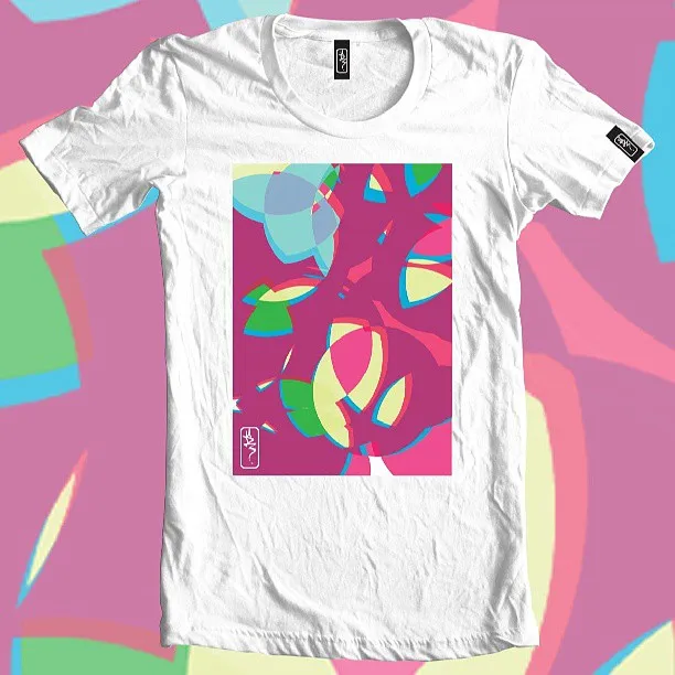 White t-shirt featuring a vibrant abstract psychedelic illustration in pink, blue, and green