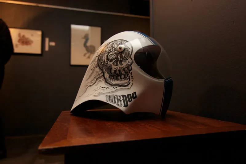 Hand-painted white helmet featuring a black and white skull illustration and the text ROB DOG