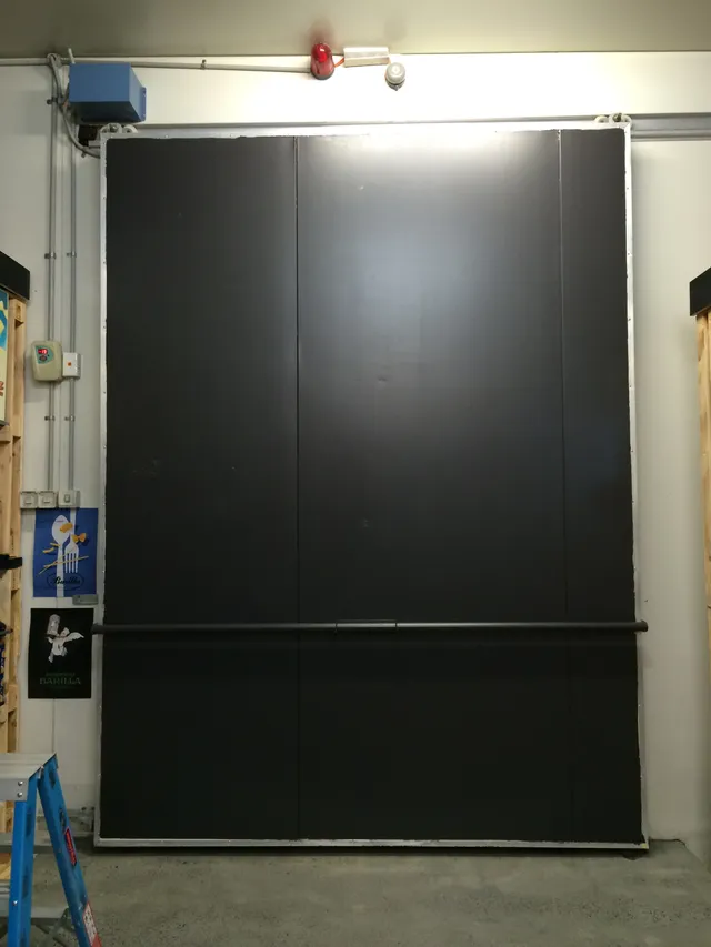 Large blank black wall panel in an industrial space