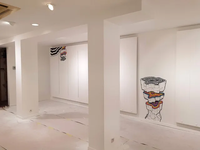 Retail mural on a white wall showing stacked rock segments with colorful, psychedelic cross-sections