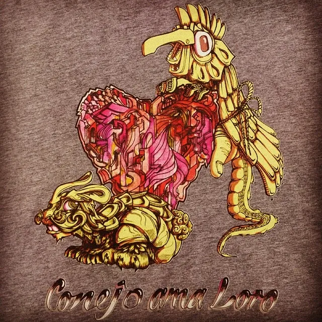 Illustration on fabric of a golden rabbit and parrot flanking a geometric pink heart above text Conejo ama Loro