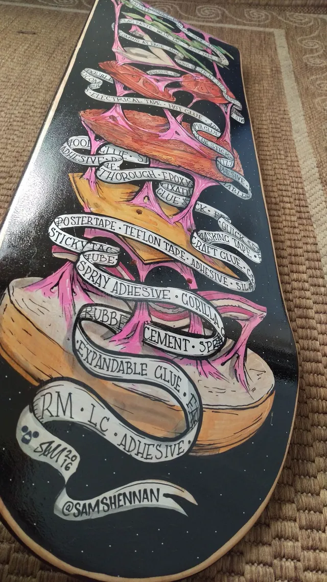 Painted skateboard depicting a stretching burger connected by pink goo and wrapped in ribbons listing adhesives